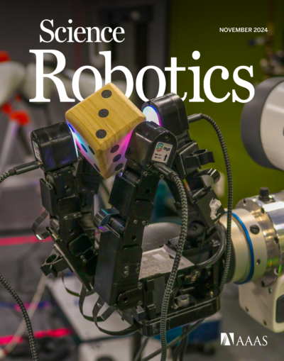  The cover of Science Robotics shows a robotic hand grasping a die.